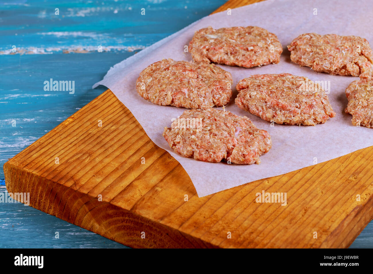 Raw Ground beef meat Burger steak cutlets with seasoning on vintage