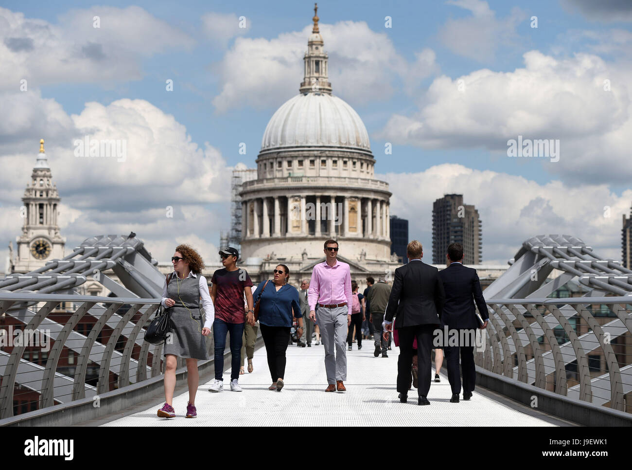 Pedestrians use the Millennium Bridge to cross the River Thames from St