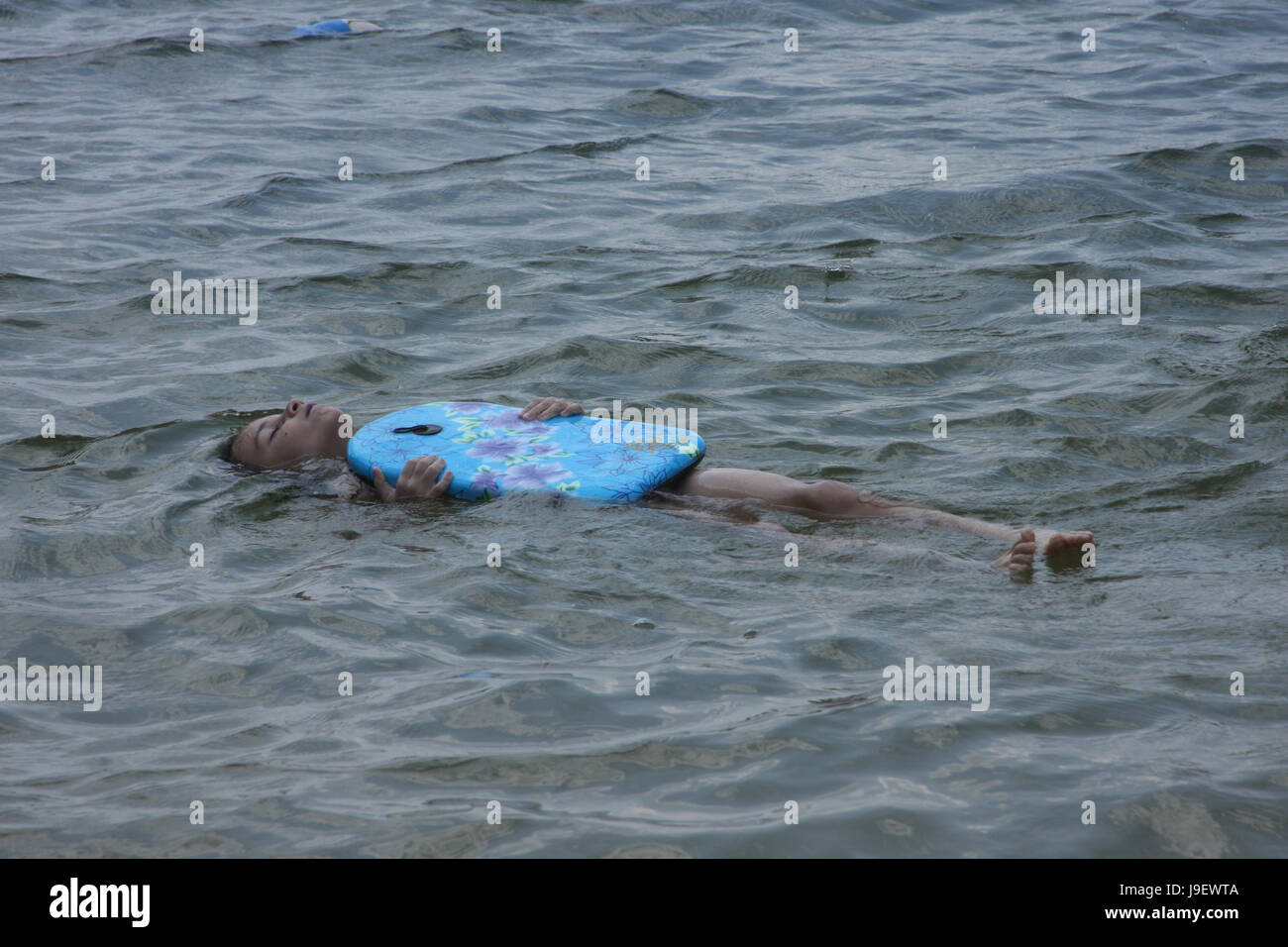 Child floating on lake water with swim board Stock Photo Alamy