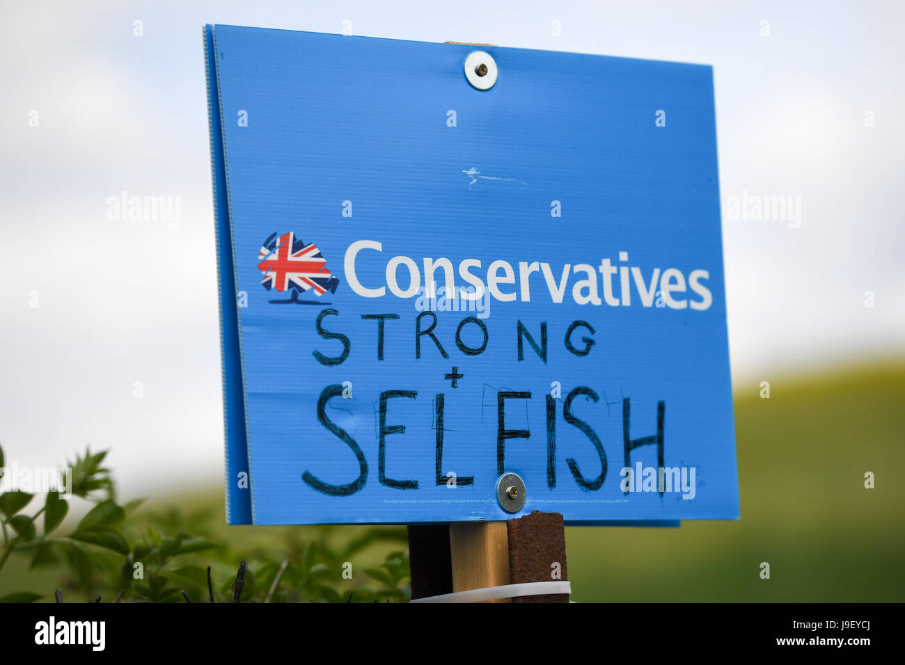 Election 2017. Conservatives board defaced. Stock Photo