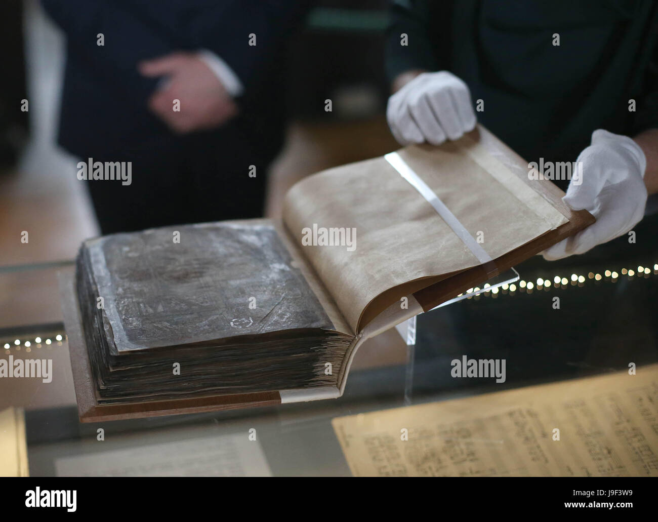 One of the Irish Manuscripts from the Dark Ages are viewed at their unveiling in the Long Room, Old Library, Trinity College Dublin. Stock Photo