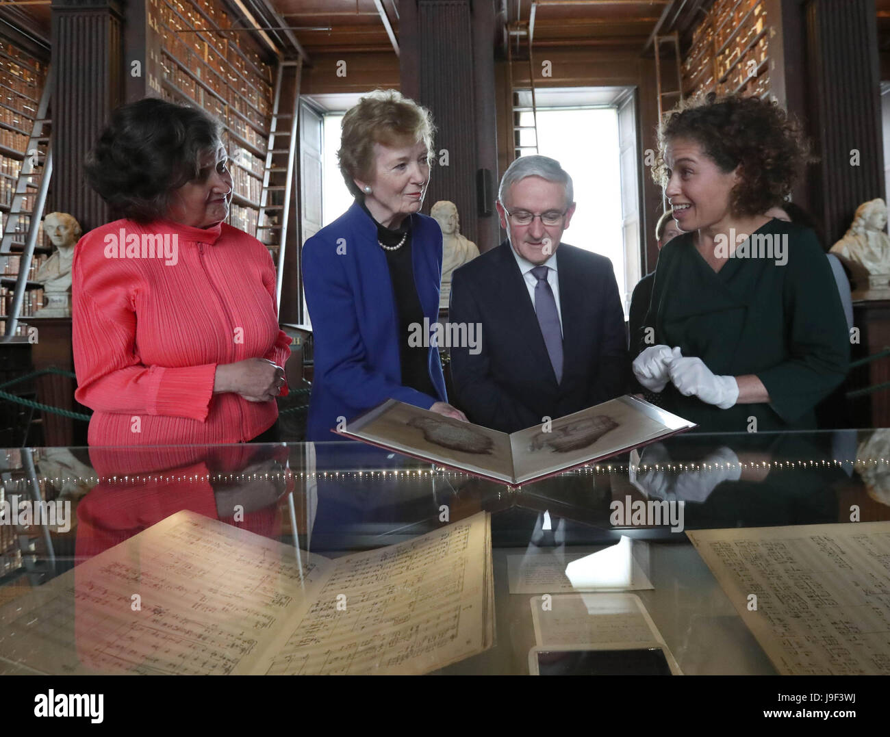 (left to right) College Librarian and Archivist Helen Shenton, Dr Mary Robinson Chancellor of the University of Dublin Trinity College, Bank of America Merrill Lynch Country Executive for Ireland Peter Keegan and Conservatist Clodagh Neligan view Irish Manuscripts from the Dark Ages at their unveiling in the Long Room, Old Library, Trinity College Dublin. Stock Photo