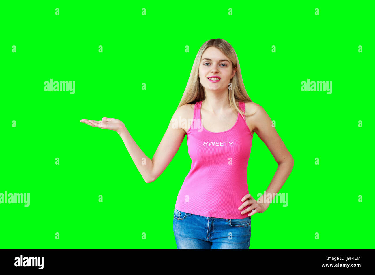 Woman showing your product or message smiling happy Isolated on green screen  chroma key background. Beautiful girl in pink tank top showing open hand  Stock Photo - Alamy