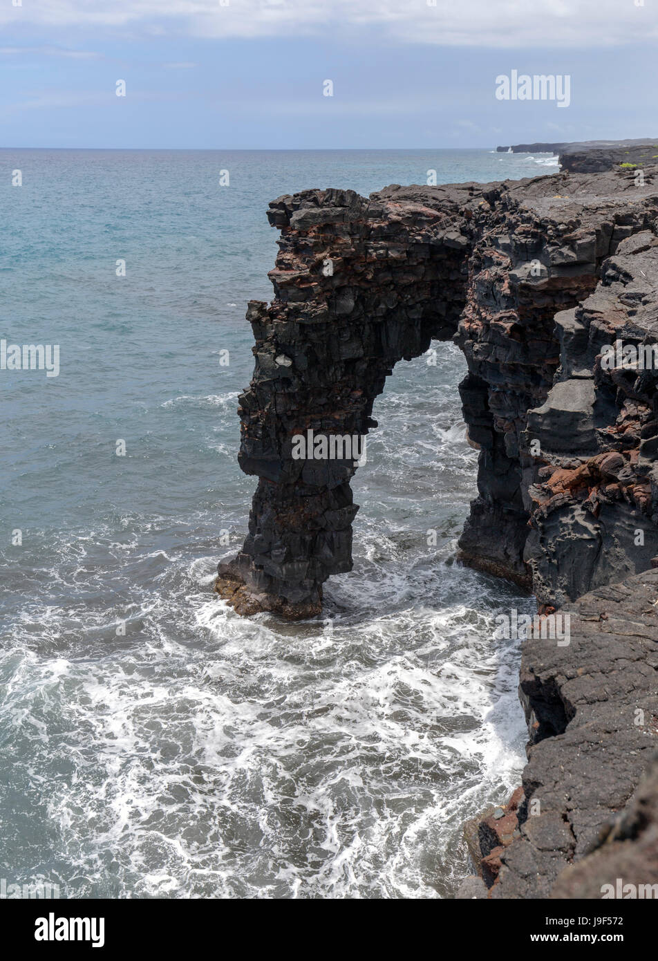 Holding sea arch in the Volcanoes National Park, Hawaii. Stock Photo