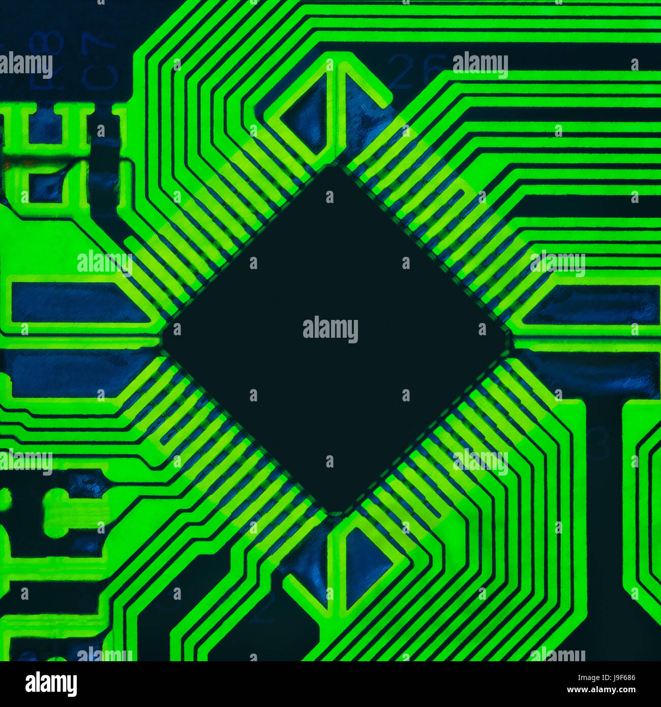 Abstract photo of an electrical board with a microprocessor in the center Stock Photo