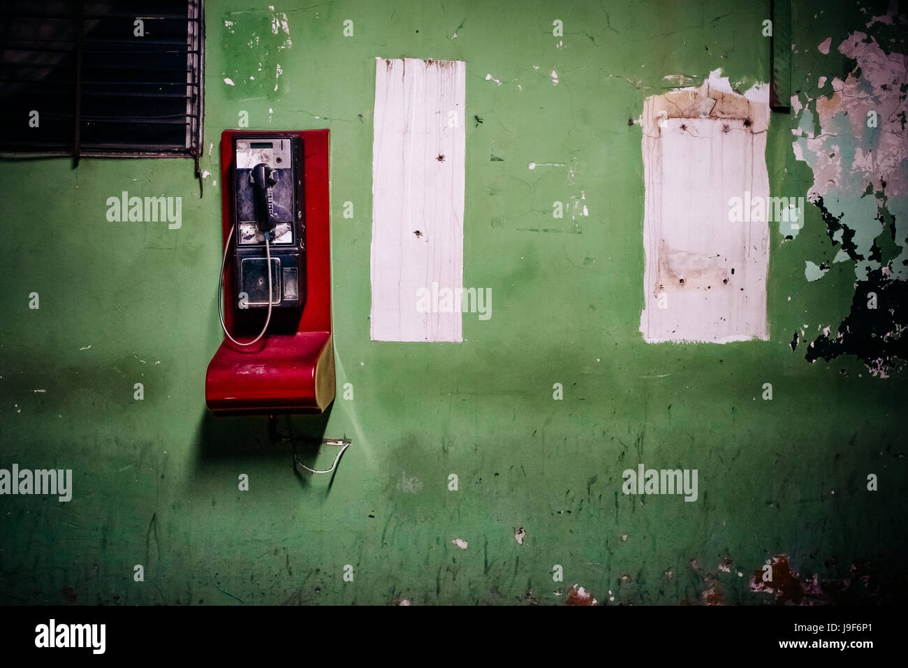 A public pay phone is seen hung on the wall in a patio inside the emergency department of a public hospital in San Salvador, El Salvador, 16 December 2015. Stock Photo