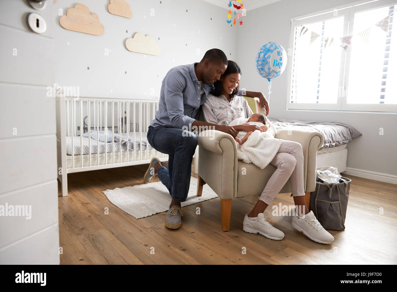 Parents Home from Hospital With Newborn Baby In Nursery Stock Photo - Alamy