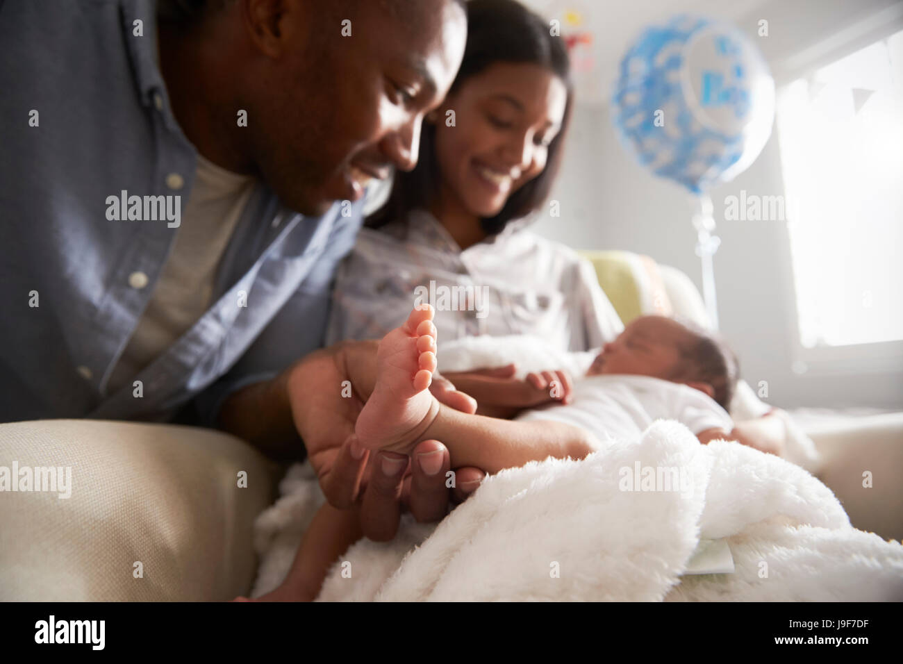 Parents Home From Hospital With Newborn Baby Stock Photo