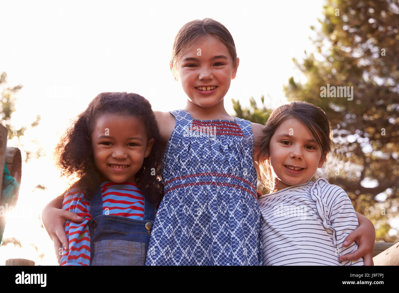 Portrait Of Three Girls Playing Outdoors At Home In Garden Stock Photo ...