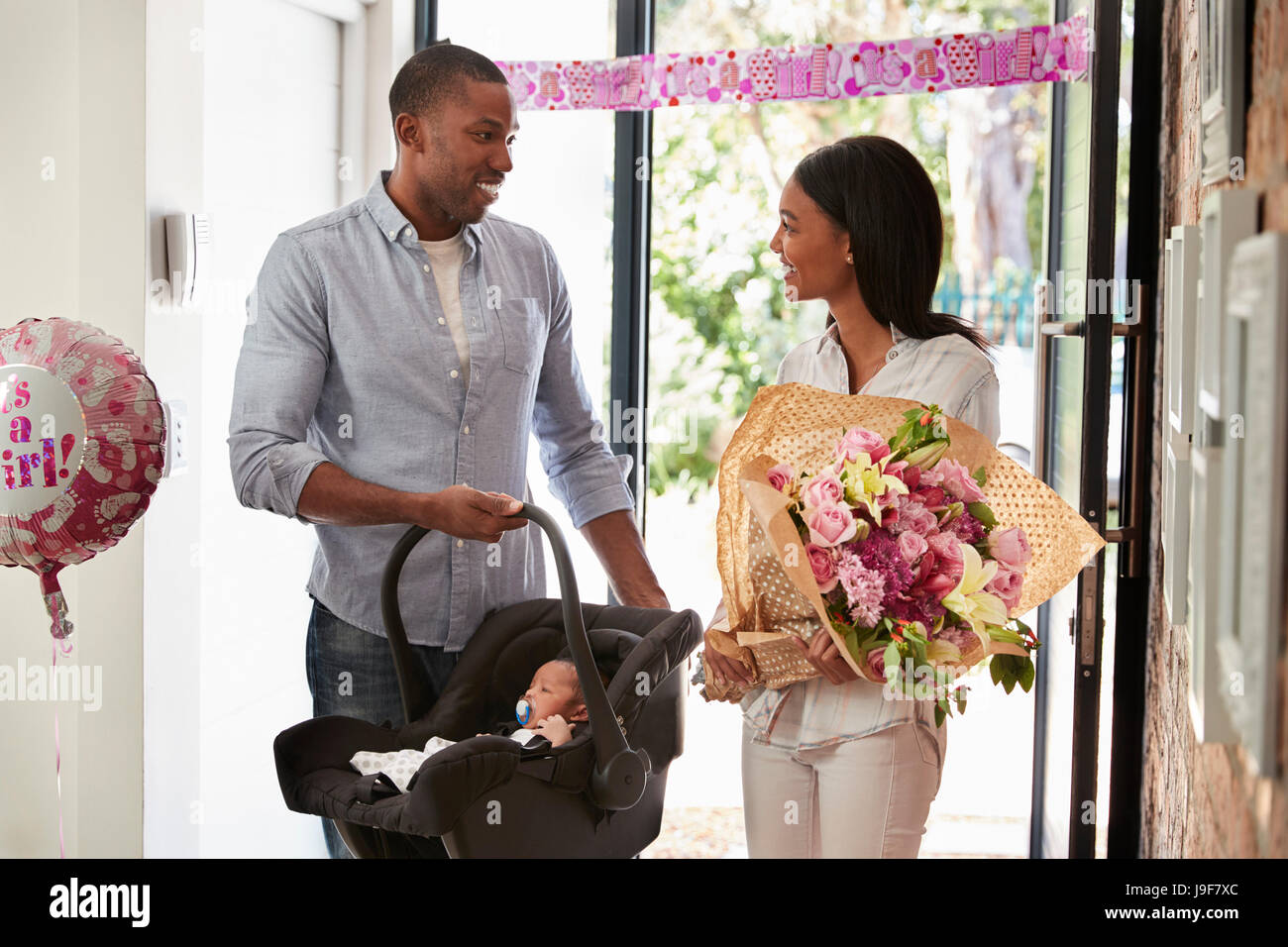 Parents Arriving Home With Newborn Baby In Car Seat Stock Photo Alamy