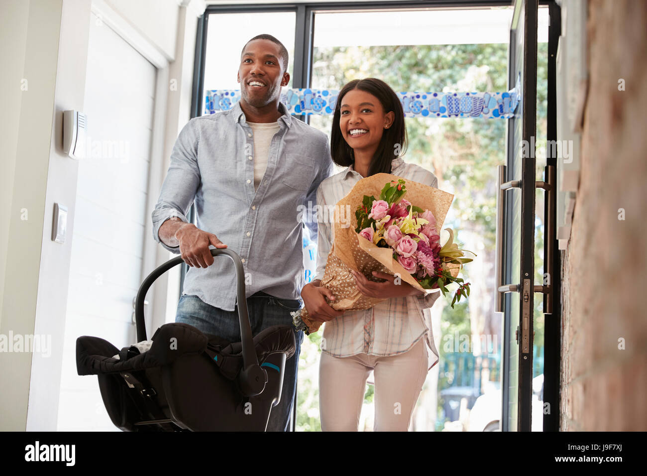 Parents Arriving Home With Newborn Baby In Car Seat Stock Photo Alamy