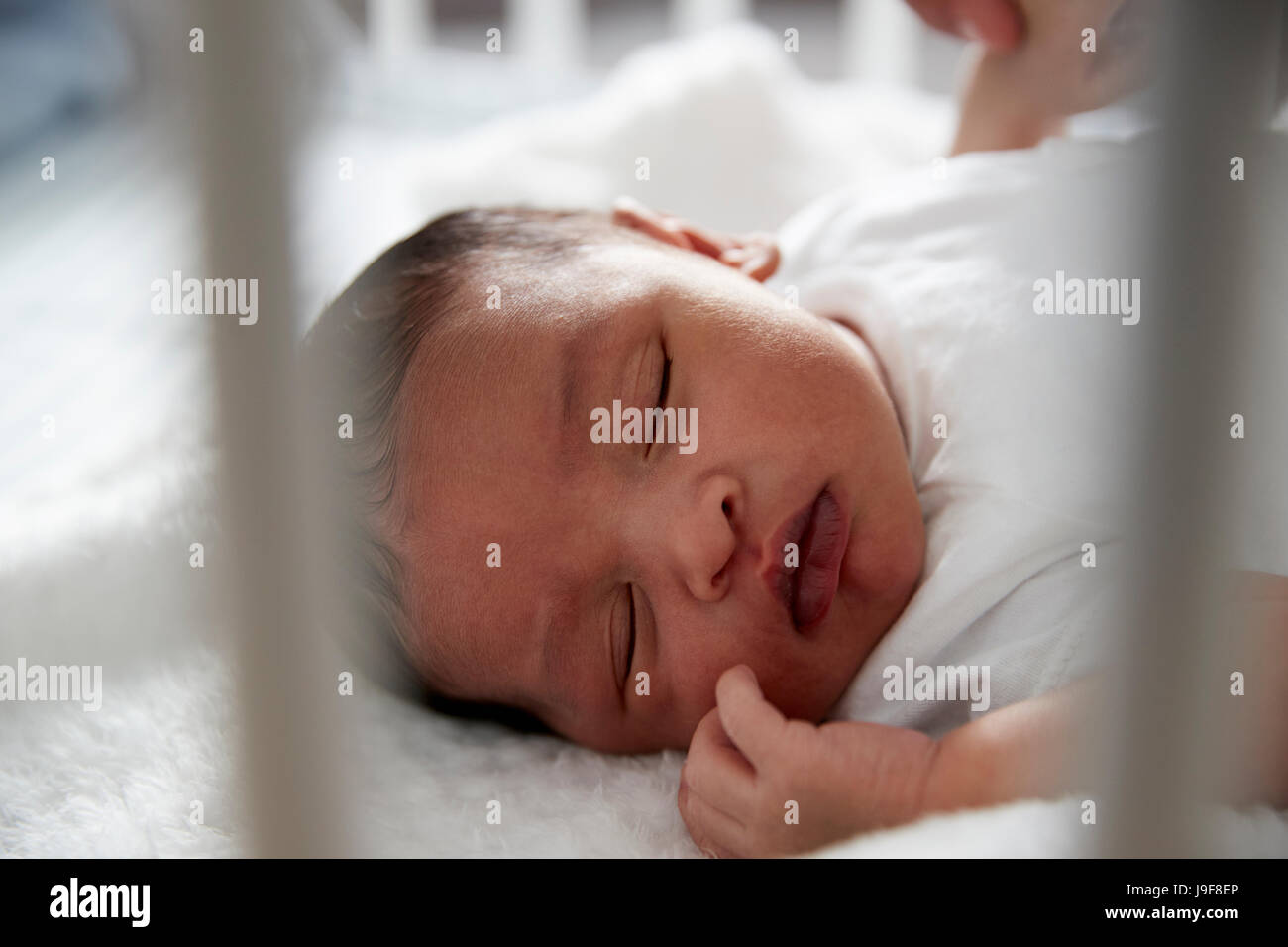 Newborn Baby Sleeping In Nursery Cot Stock Photo Alamy