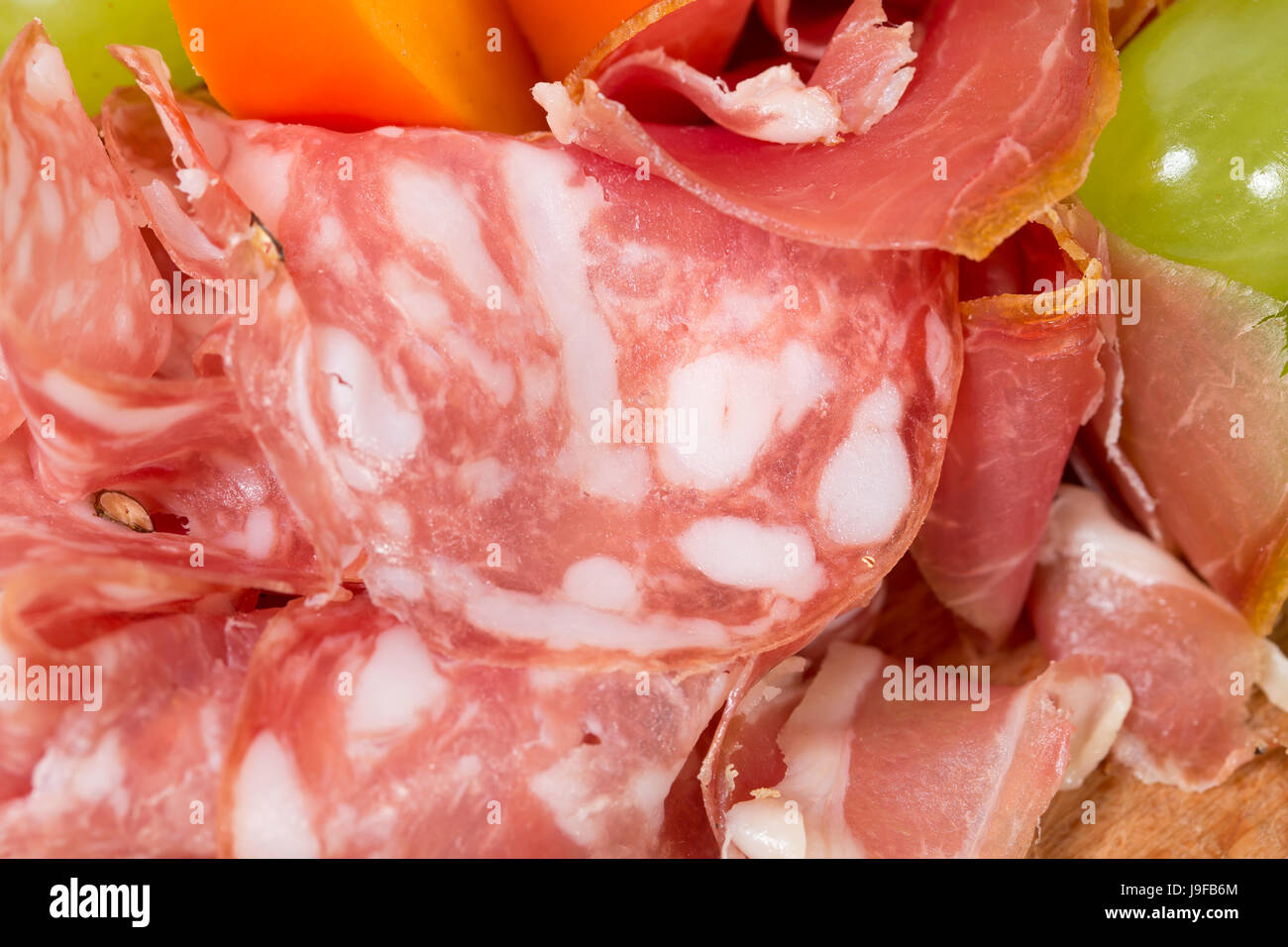 Mixed italian dried meats platter. Macro. Photo can be used as a whole background. Stock Photo