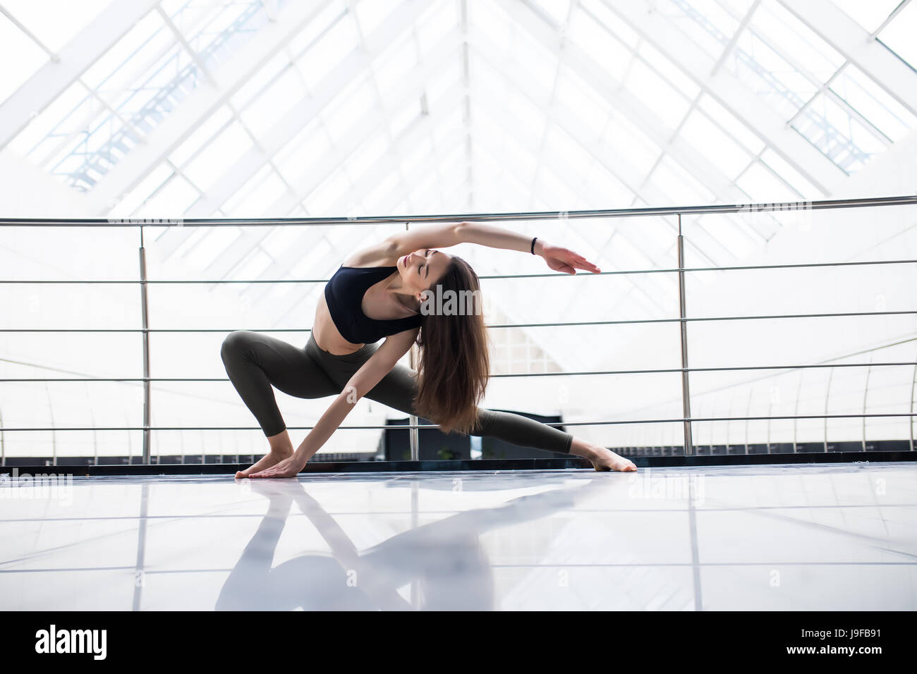 Yoga woman practice in a training hall background. Yoga concept. Stock Photo