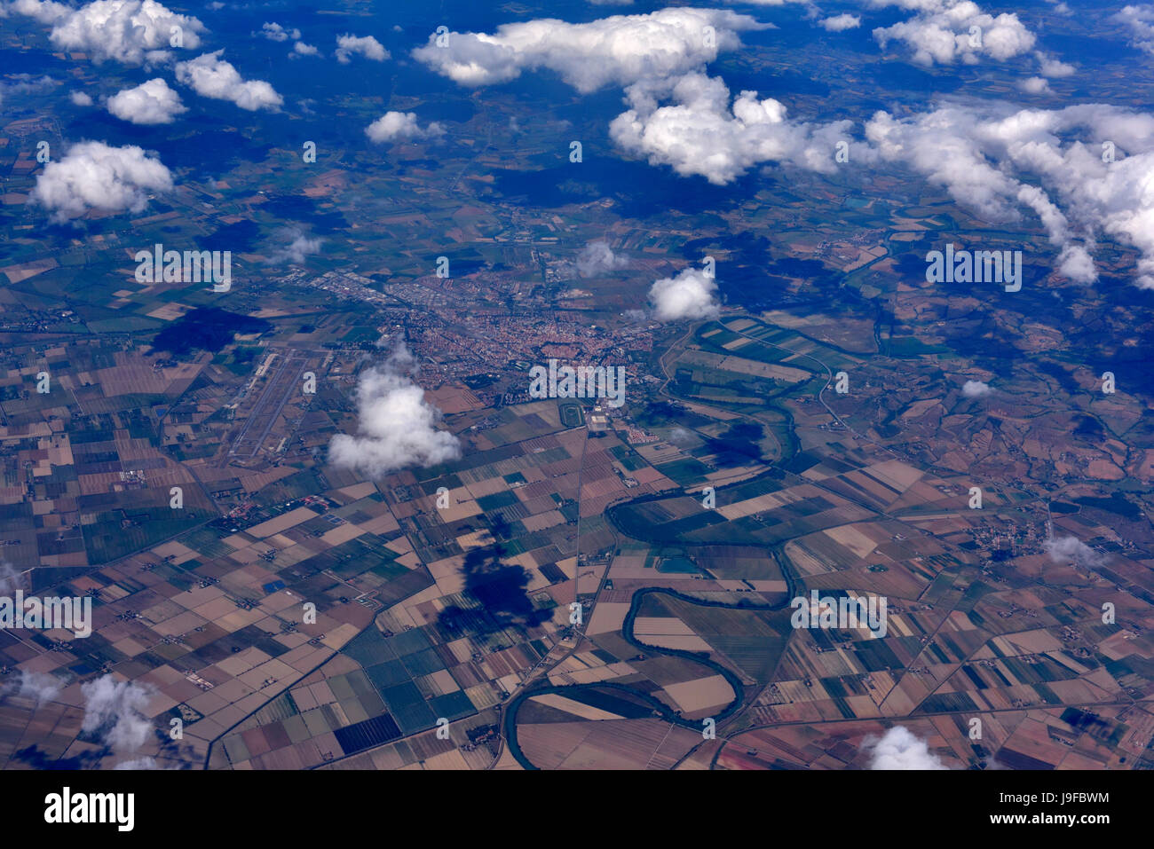 Aerial view of agricultural fields in Tuscany, Italy, along the Ombrone river and city of Grosseto Stock Photo