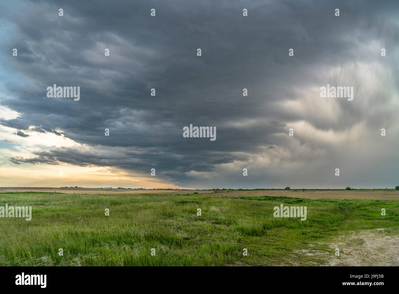 heavy storm clouds and rain over Nebraska farmland in spring Stock Photo