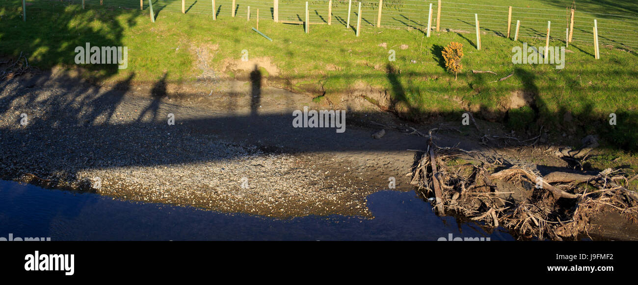 Shadows of people walking on a bridge Stock Photo - Alamy