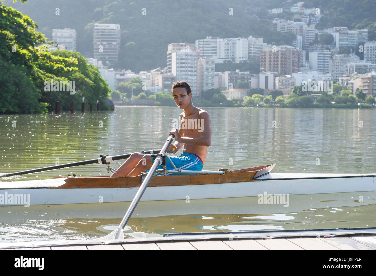 RIO DE JANEIRO - MARCH 14, 2016: A young Brazilian rower launches his ...