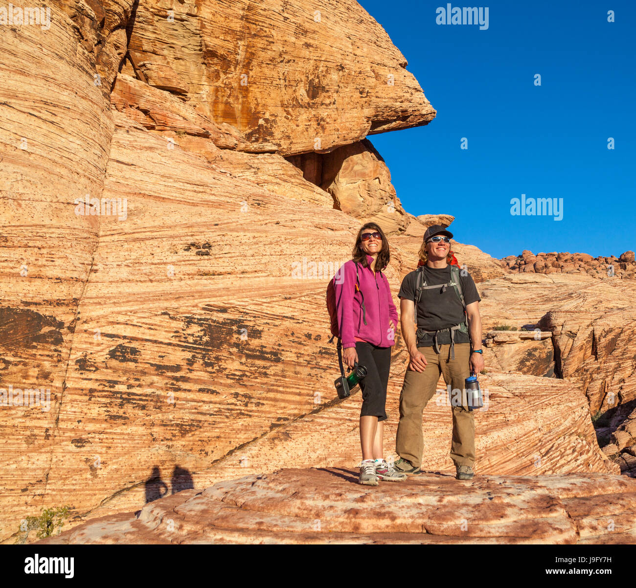 Couple see golden light at sunset at Red Rock Canyon National Conservation Area, which is about 20 miles from Las Vegas Stock Photo
