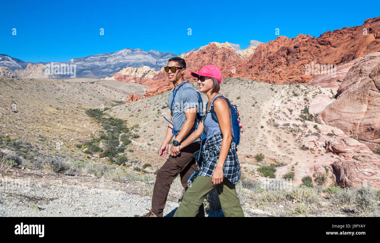 Couple with rock climbing gear  hike  at Red Rock Canyon National Conservation Area, which is about 20 miles from Las Vegas Stock Photo