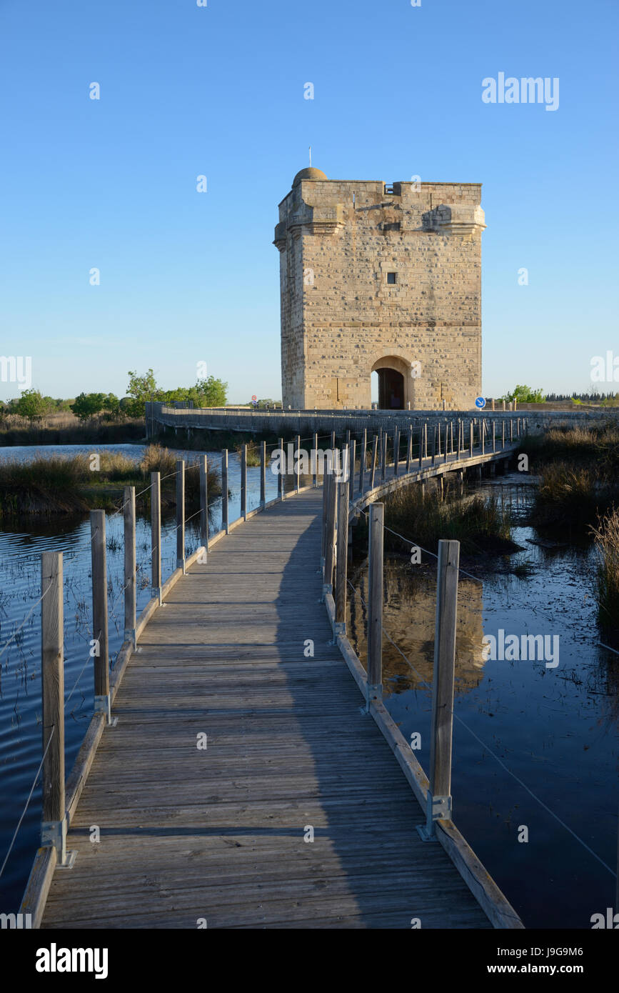 Wooden Boardwalk and the Medieval Tour Carbonnière or Carbonnière Tower (c13th) which Protected the Northern Approach to Walled City of Aigues-Mortes Stock Photo