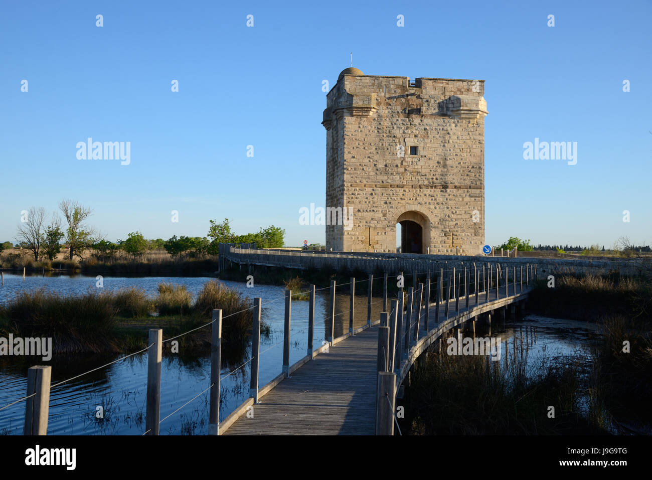 Wooden Boardwalk and the Medieval Tour Carbonnière or Carbonnière Tower (c13th) which Protected the Northern Approach to Walled City of Aigues-Mortes Stock Photo