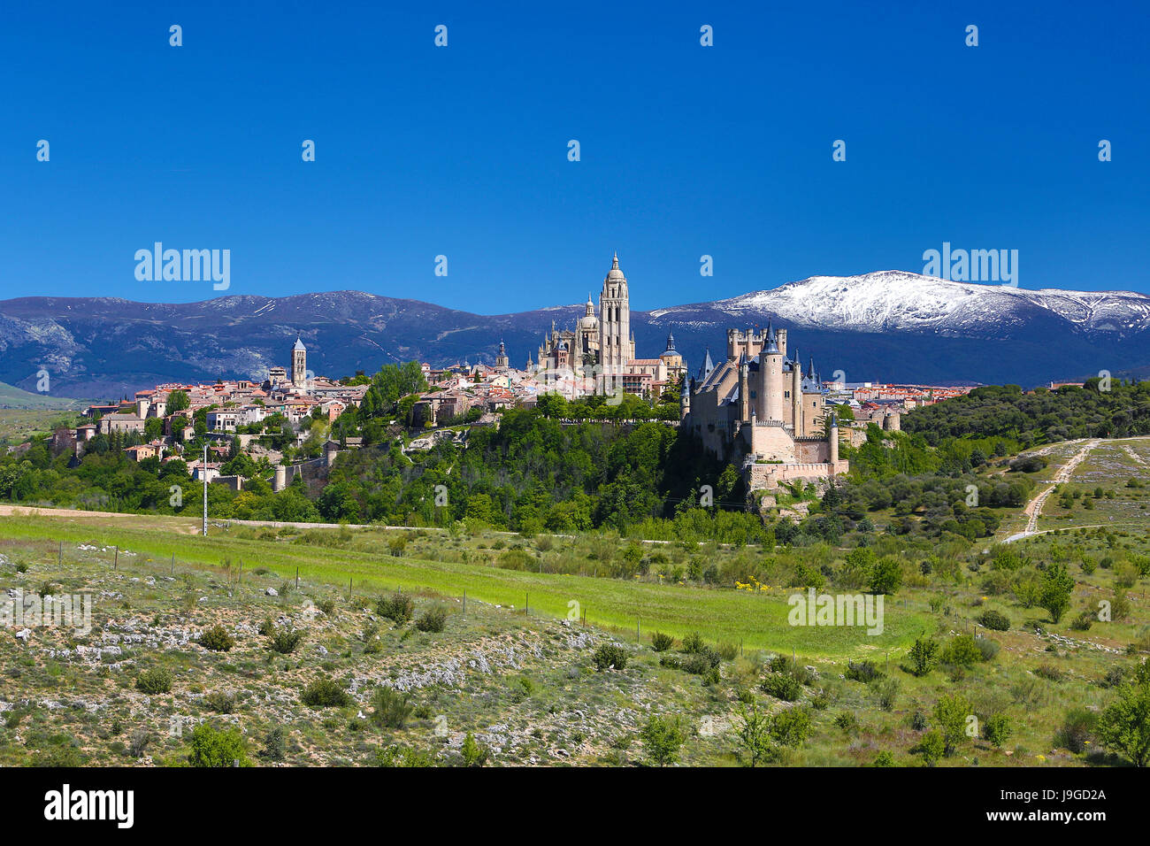 Spain, Castilla Leon Community, Segovia City Skyline, Alcazar Castle, Cathedral and Guadarrama Mountain Range, Stock Photo