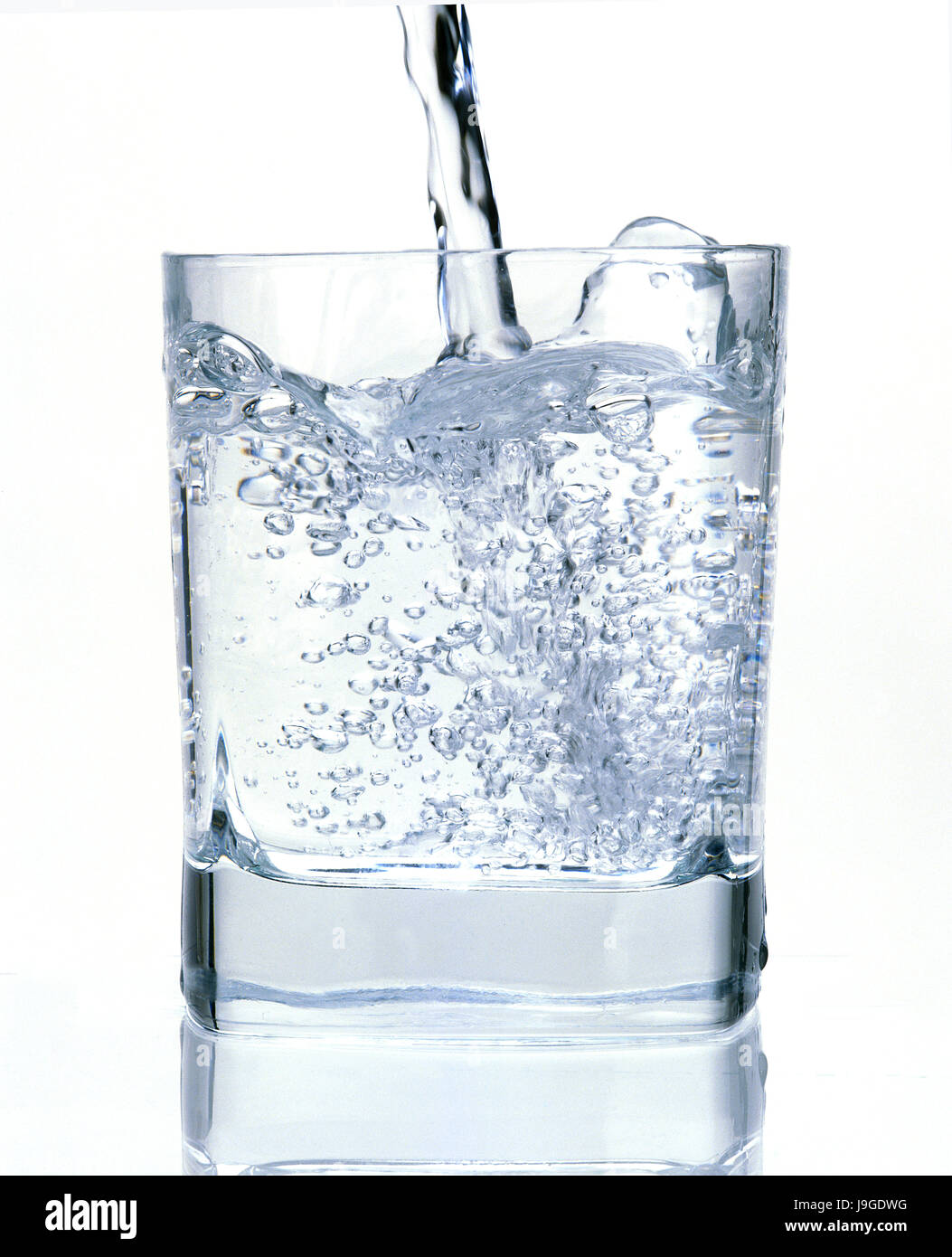 Water being Poured in a Glass against White Background Stock Photo Alamy