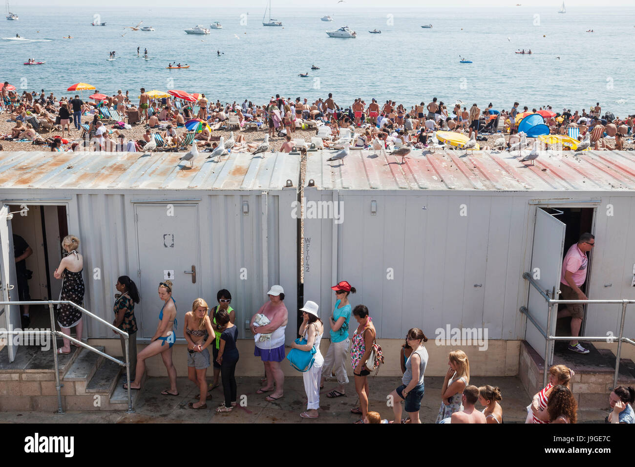England, East Sussex, Brighton, Brighton Beach, Line of Women Queuing for Ladies Toilet Stock ...