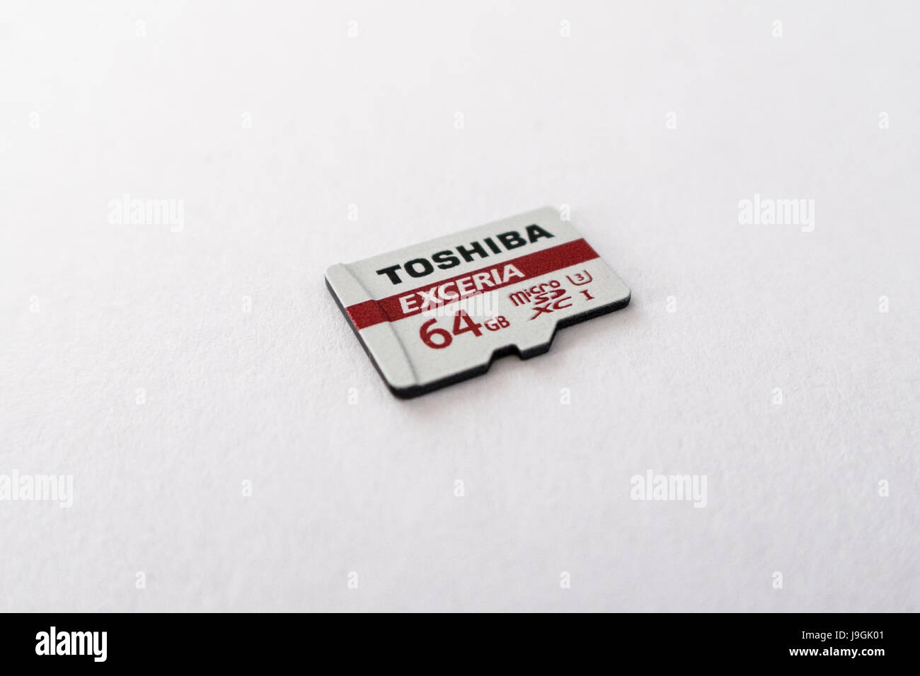Toshiba Exceria microSD XC memory card with a capacity of 64GB on white background. Stock Photo