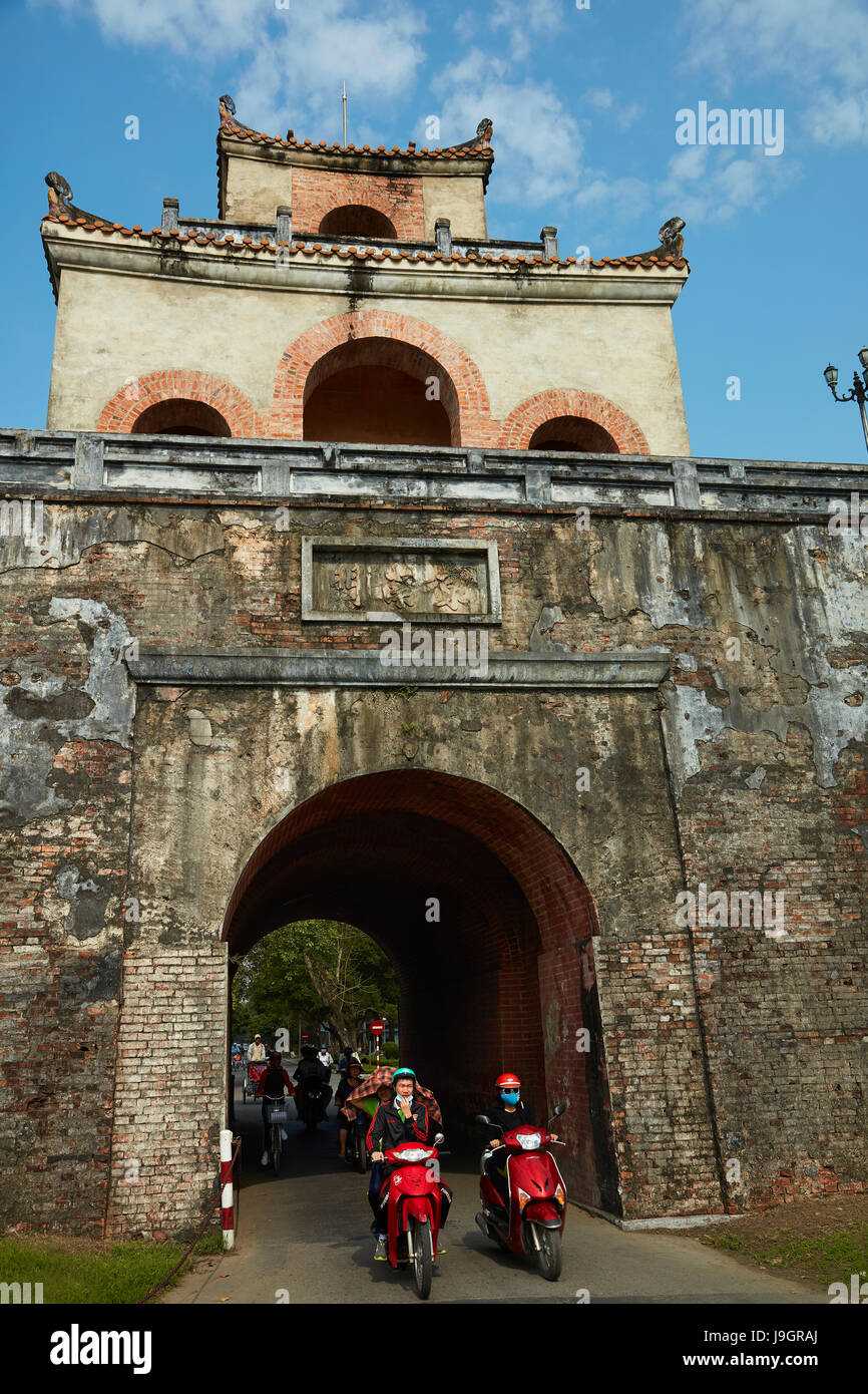 Motorbikes coming out gate from historic Hue Citadel (Imperial City), Hue, North Central Coast, Vietnam Stock Photo