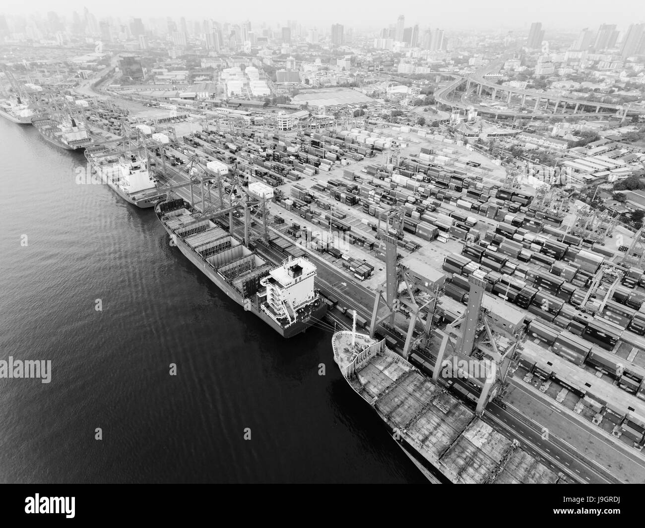 container,container ship in import export and business lo gistic,By crane ,Trade Port , Shipping,cargo to harbor, Aerial view,Water transport,Internat Stock Photo