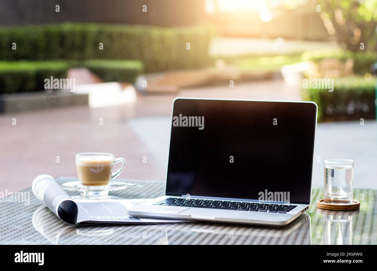 select focus blank mornitor for copy space laptop on table with mobile phone and drink unplug freelance work life Stock Photo