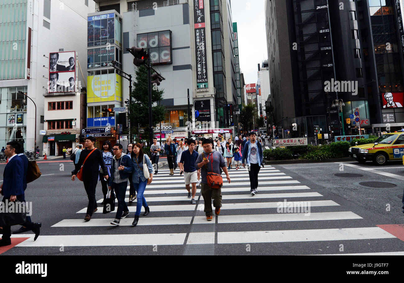 Pedestrians crossing busy roads in Shinjuku, Tokyo. Stock Photo