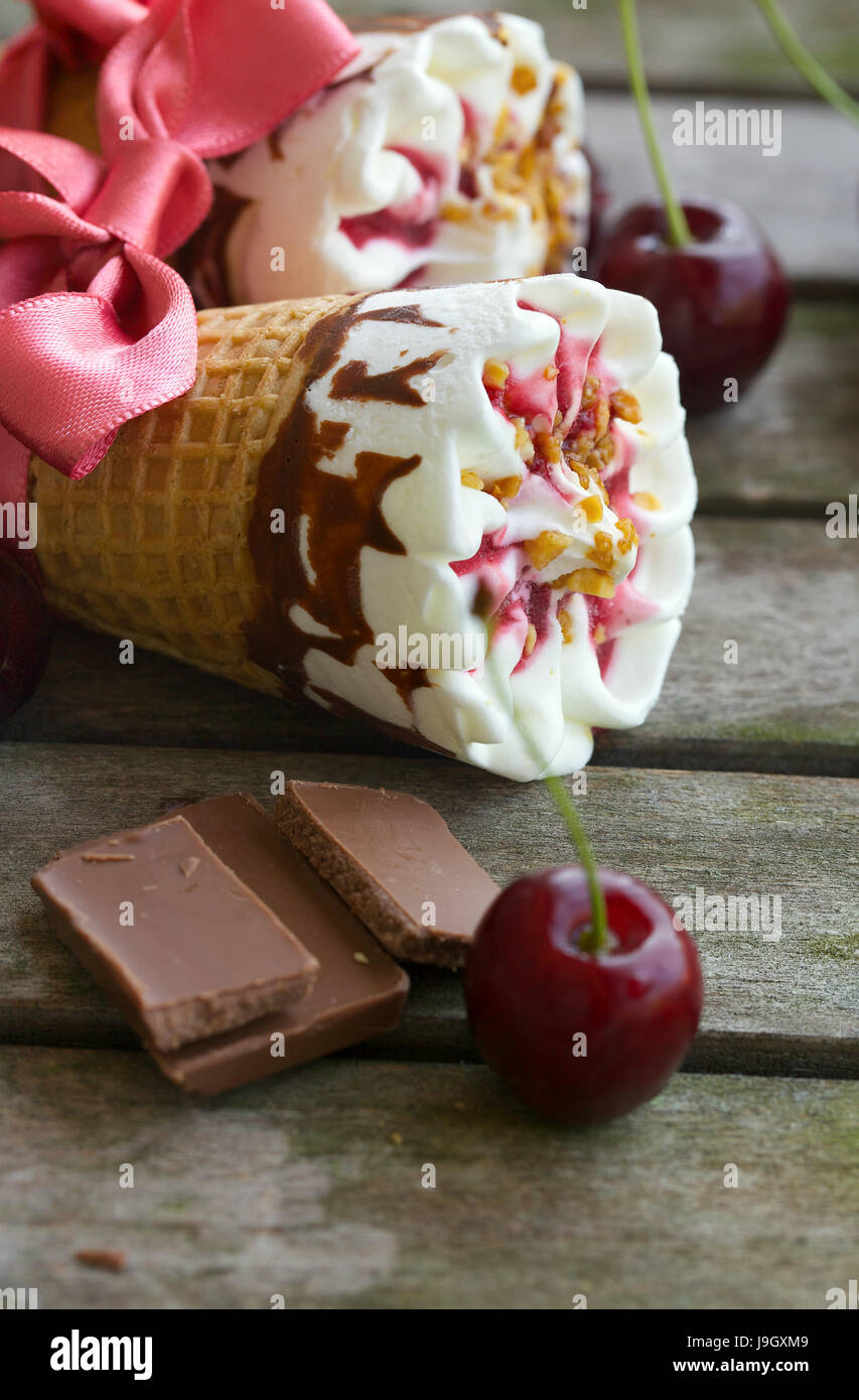 Cherry vanilla ice-cream with caramel topping and chocolate. Closeup