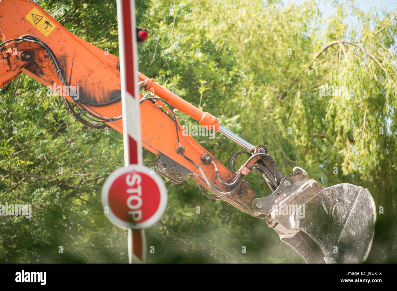 raised red and white barrier stop sign, in foreground blurred green ...