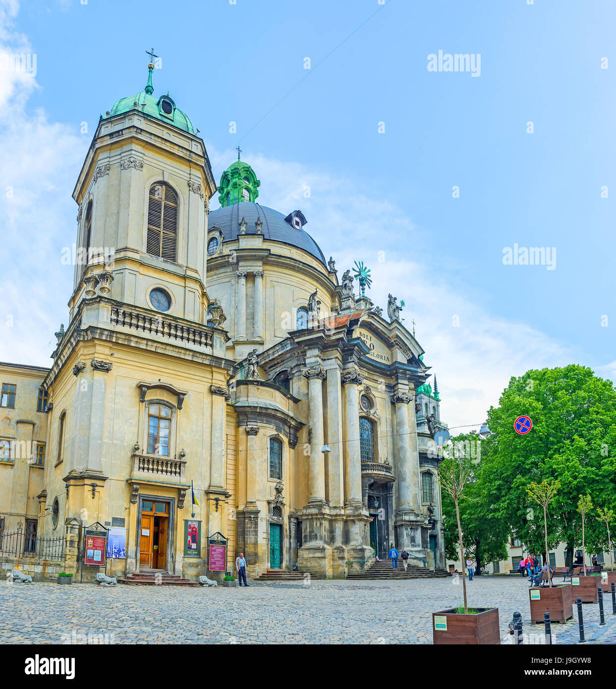 LVOV, UKRAINE - MAY 16, 2017: Impressive facade of Dominican church (Holy Eucharist) with huge bell tower and dome, tall columns t the entrance, on Ma Stock Photo