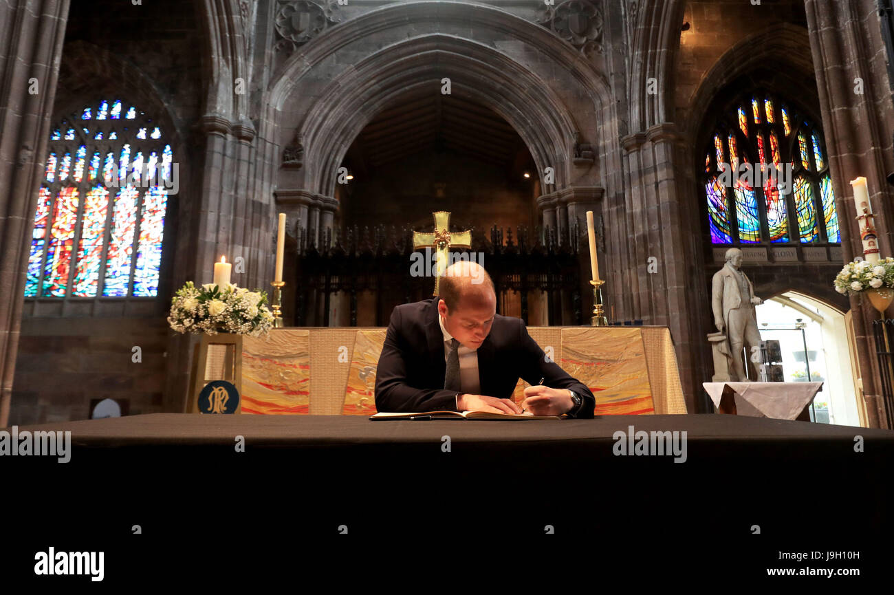 The Duke of Cambridge signs a book of condolence at Manchester Cathedral where he to met first responders and members of the local community who provided vital care and support to those affected by last week's suicide bomb attack, including representatives from St John's Ambulance, Northern Rail and the British Red Cross. Stock Photo