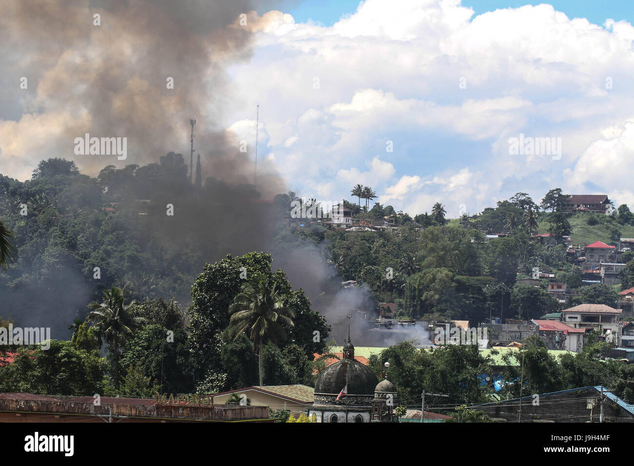 Marawi, Philippines. 2nd June, 2017. Smoke rises after an airstrike in the town of Marawi, southern Philippines . June 2, 2017. The governemnt troops advance their positions as they assault the Islamist Militant Maute group. Credit: Linus Guardian Escandor Ii/ZUMA Wire/Alamy Live News Stock Photo