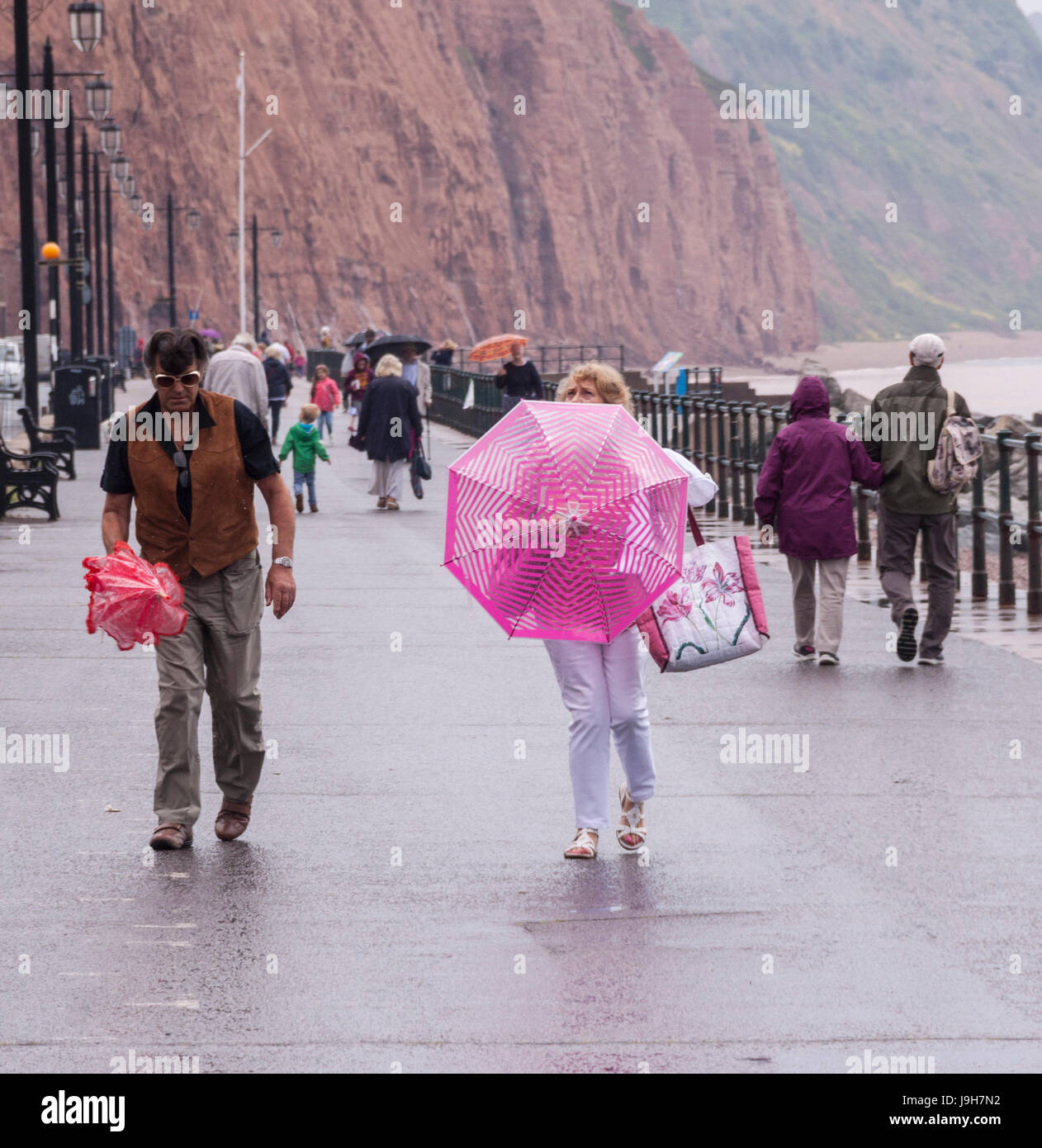 Sidmouth, Devon, 2nd June 17 Umbrellas to the fore in Sidmouth, as light rain sweeps across the Souith West Credit: Photo Central/Alamy Live News Stock Photo