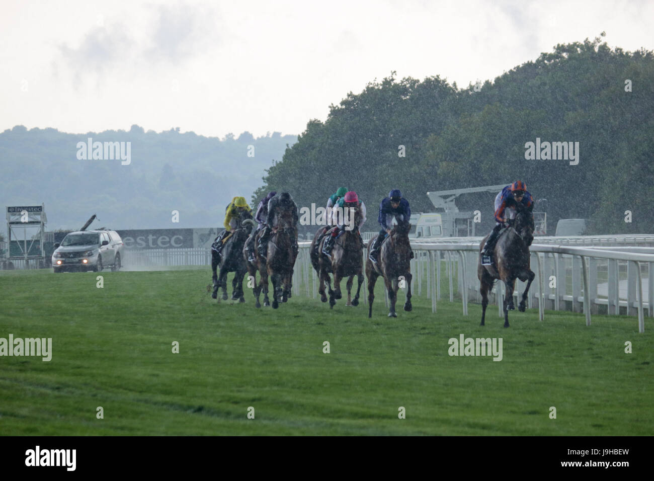 Epsom Downs, Surrey, UK. 2nd June 2017. Ladies Day on Epsom Downs in Surrey. The runners and riders of the 4.30 Investec Oaks head around the top bend with thunder, lightening and torrential rain. Credit: Julia Gavin UK/Alamy Live News Stock Photo