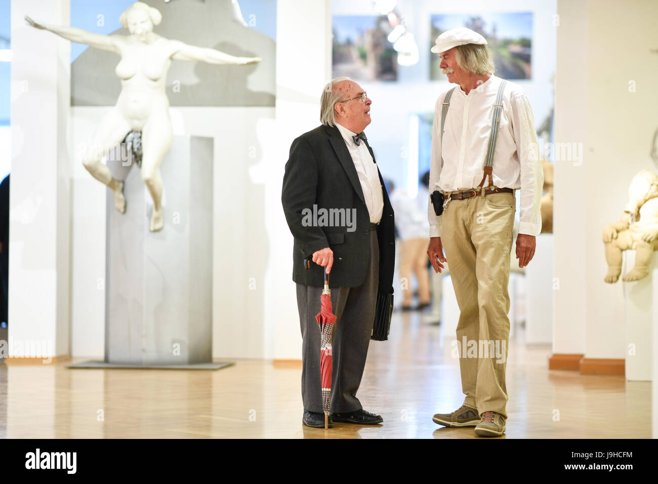 Ueberlingen, Germany. 1st June, 2017. Artist Peter Lenk (r) and Professor Helmut Weidhase, literary scholard and academic council for German language and literature at the university of Konstanz, photographed at his exhibition 'Peter Lenk - 40 Jahre Zoff und Zwinkern' (lit. '40 years of trouble and winking') at the 'Staedtische Galerie' in Ueberlingen, Germany, 1 June 2017. The exhibition is open from 2 June until 15 October 2017. Photo: Felix Kästle/dpa/Alamy Live News Stock Photo