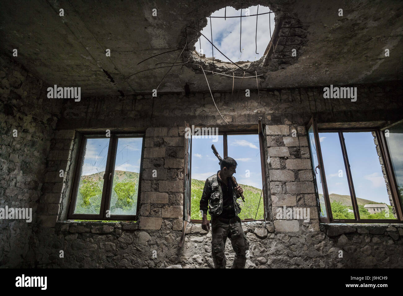 Talish, Martakert, Nagorno Karabakh. 2nd June, 2017. Member of the militia of Nagorno Karabakh in the destroyed school of Talish village, shelled with artillery by the Azerbaijan army one year ago. Credit: Celestino Arce/ZUMA Wire/Alamy Live News Stock Photo