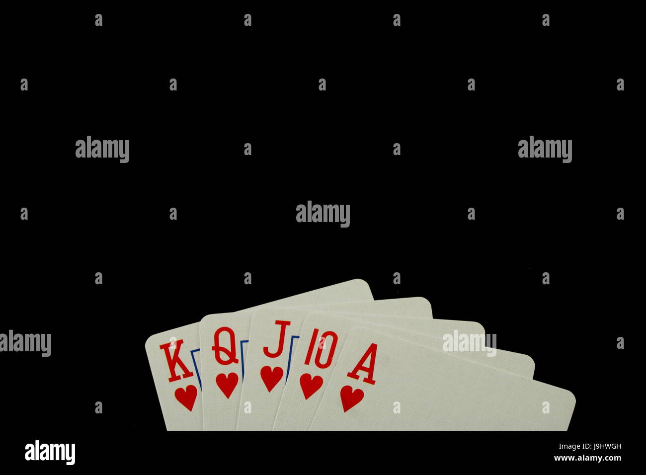 Poker Hand Royal Flush Playing Cards on Black Background Stock Photo