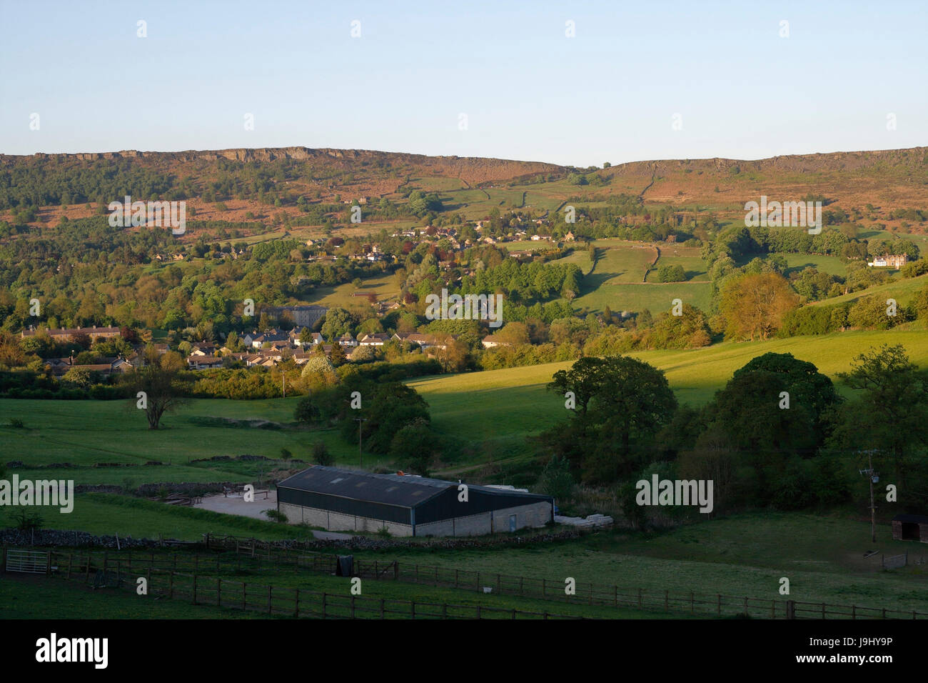 Curbar edge and Village in evening sunshine, Derbyshire Peak District Landscape England UK Stock Photo