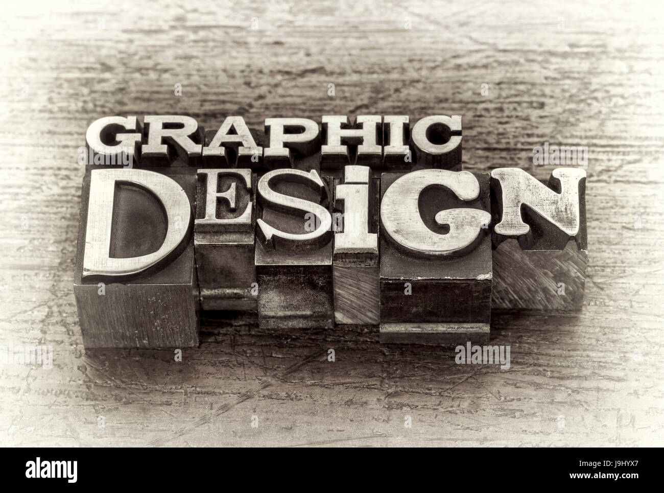 graphic design word abstract in mixed vintage metal type printing blocks over grunge wood, black and white image Stock Photo