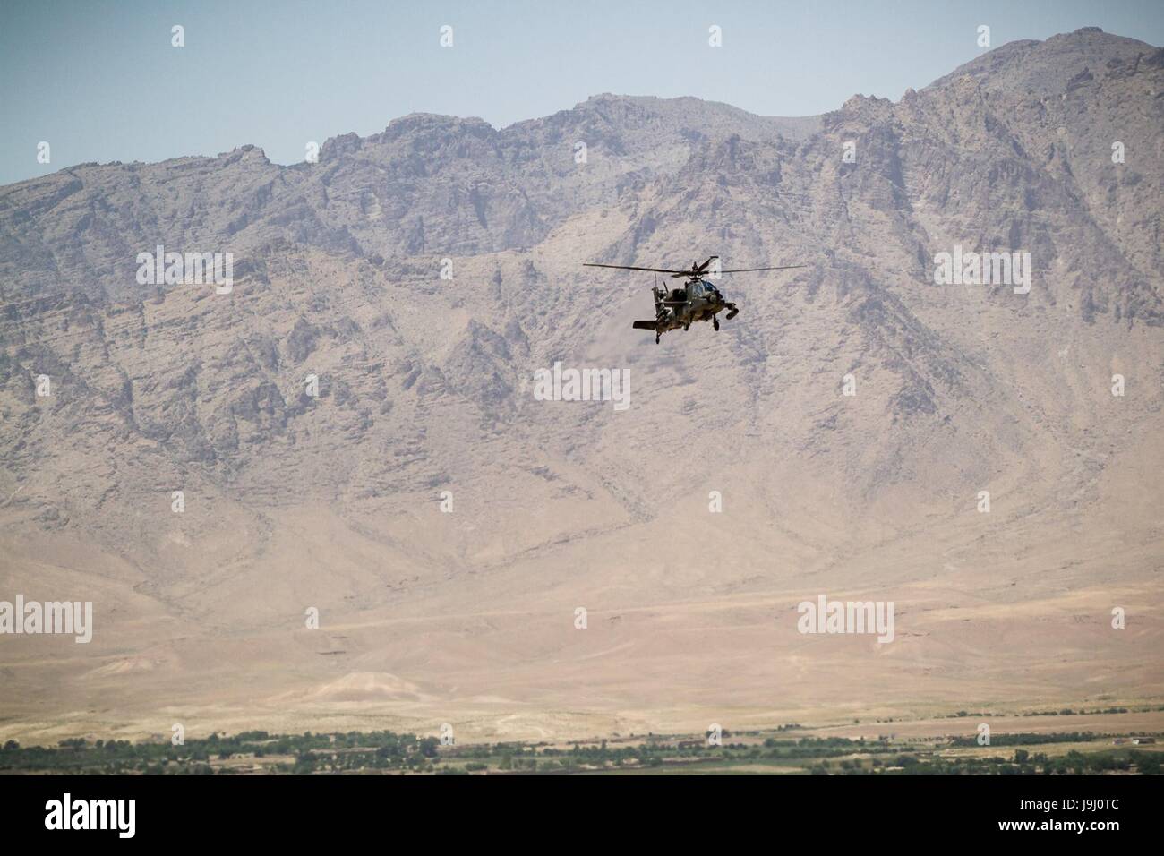 A U.S. Army AH-64 Apache helicopter assigned to Task Force Griffin, 16th Combat Aviation Brigade, during a mission in support of Operation Resolute Support May 1, 2017 in Uruzgan Province, Afghanistan. Kunduz has seen increased Taliban activity as more than 8,000 American troops and 6,000 from NATO and allied countries continue to assist the government. Stock Photo