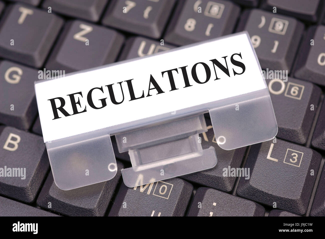 regulations marked on computer keyboard Stock Photo - Alamy