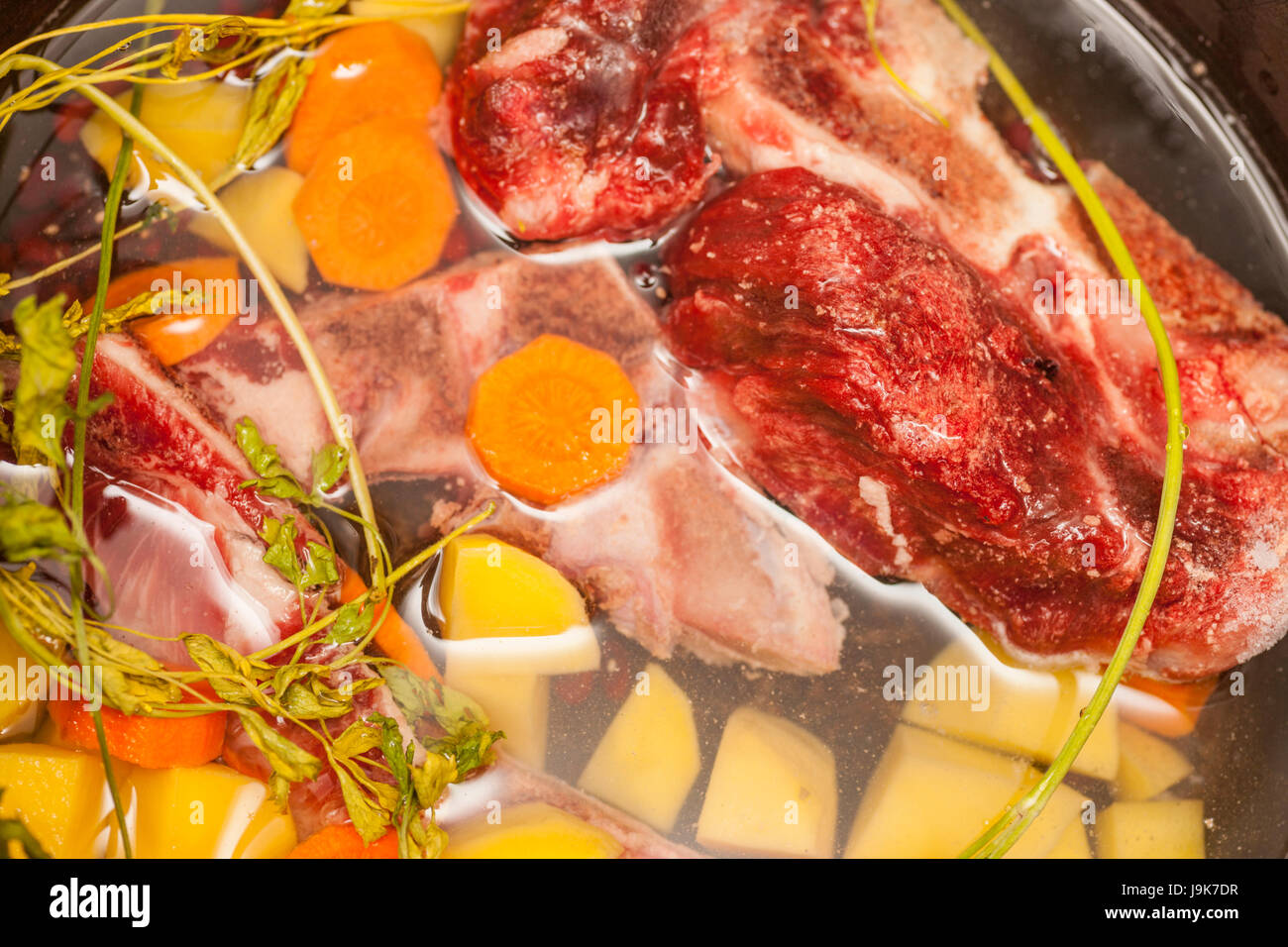 Beef bone bouillon soup cooking Ingredients in sousepan Stock Photo Alamy