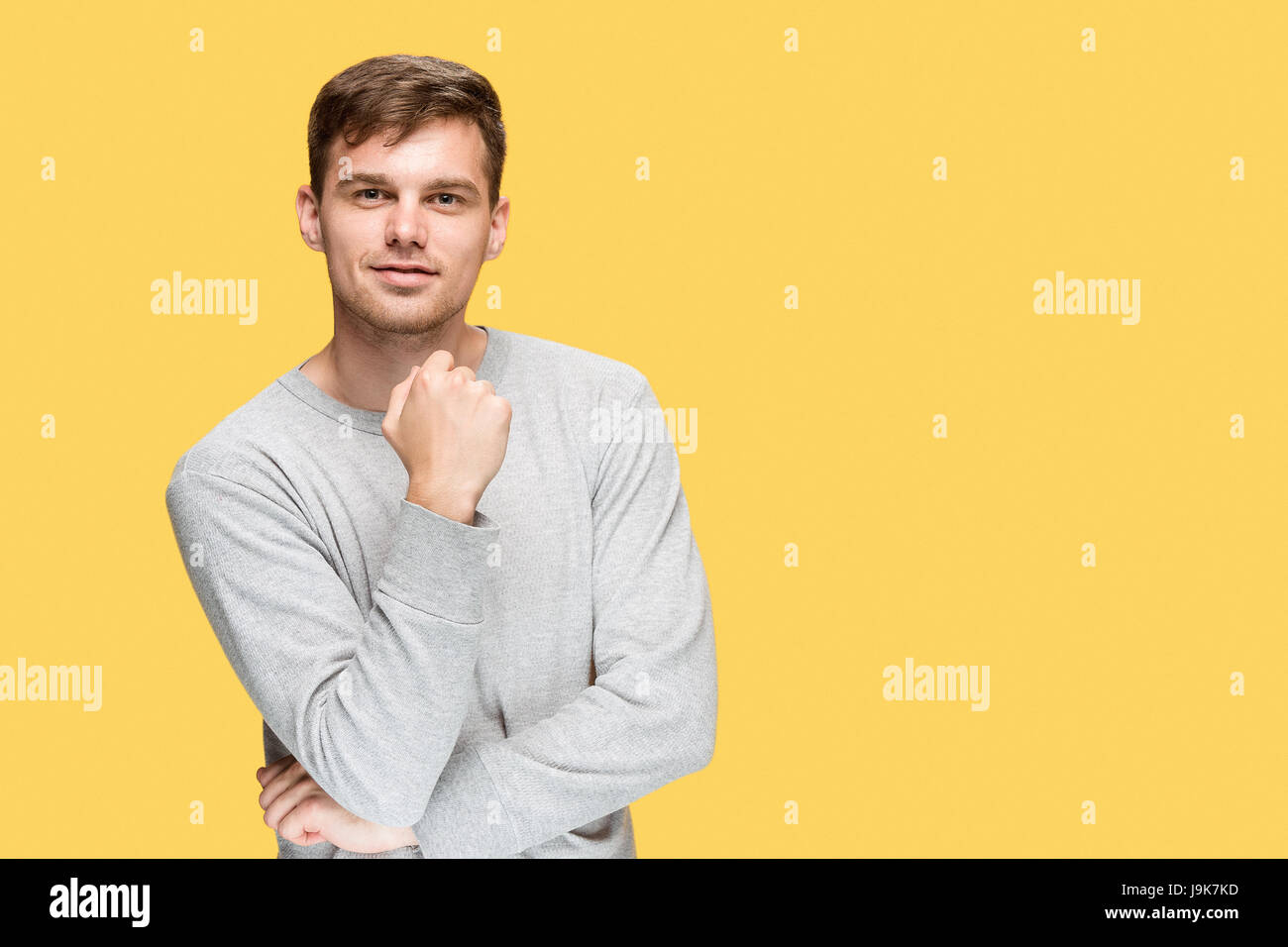 The young man smiling and looking at camera Stock Photo - Alamy